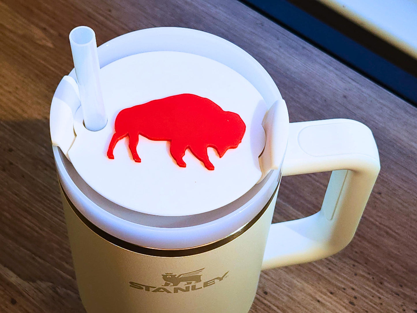 Red buffalo silhouette topper fitted on a white Stanley 40 oz tumbler, showing the bold Buffalo-inspired design for football fans.
