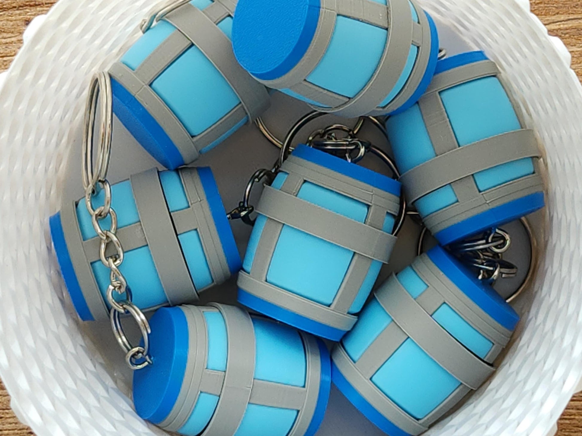 A close up picture of a basket full of Chug Jug keychains from Fortnite. The top has a mechanical clicker that can be used for anti-stress or fidgeting.