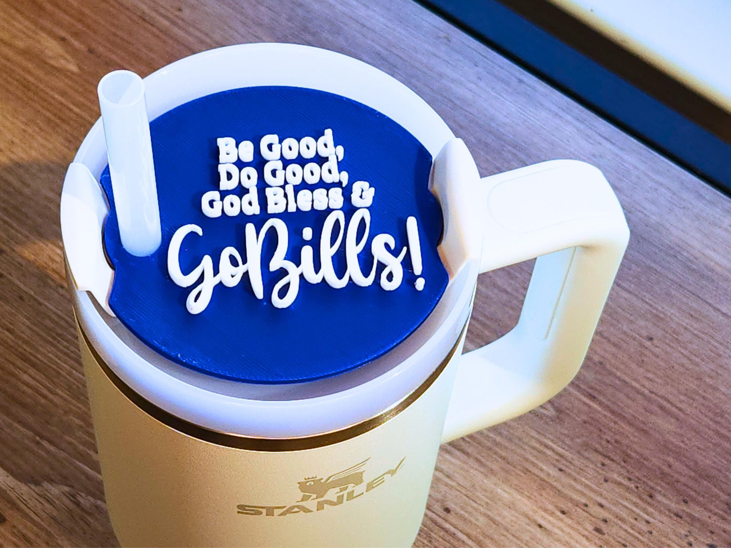 Blue Stanley topper with white text Be Good, Do Good, God Bless & Go Bills fitted on a Stanley tumbler with straw.
