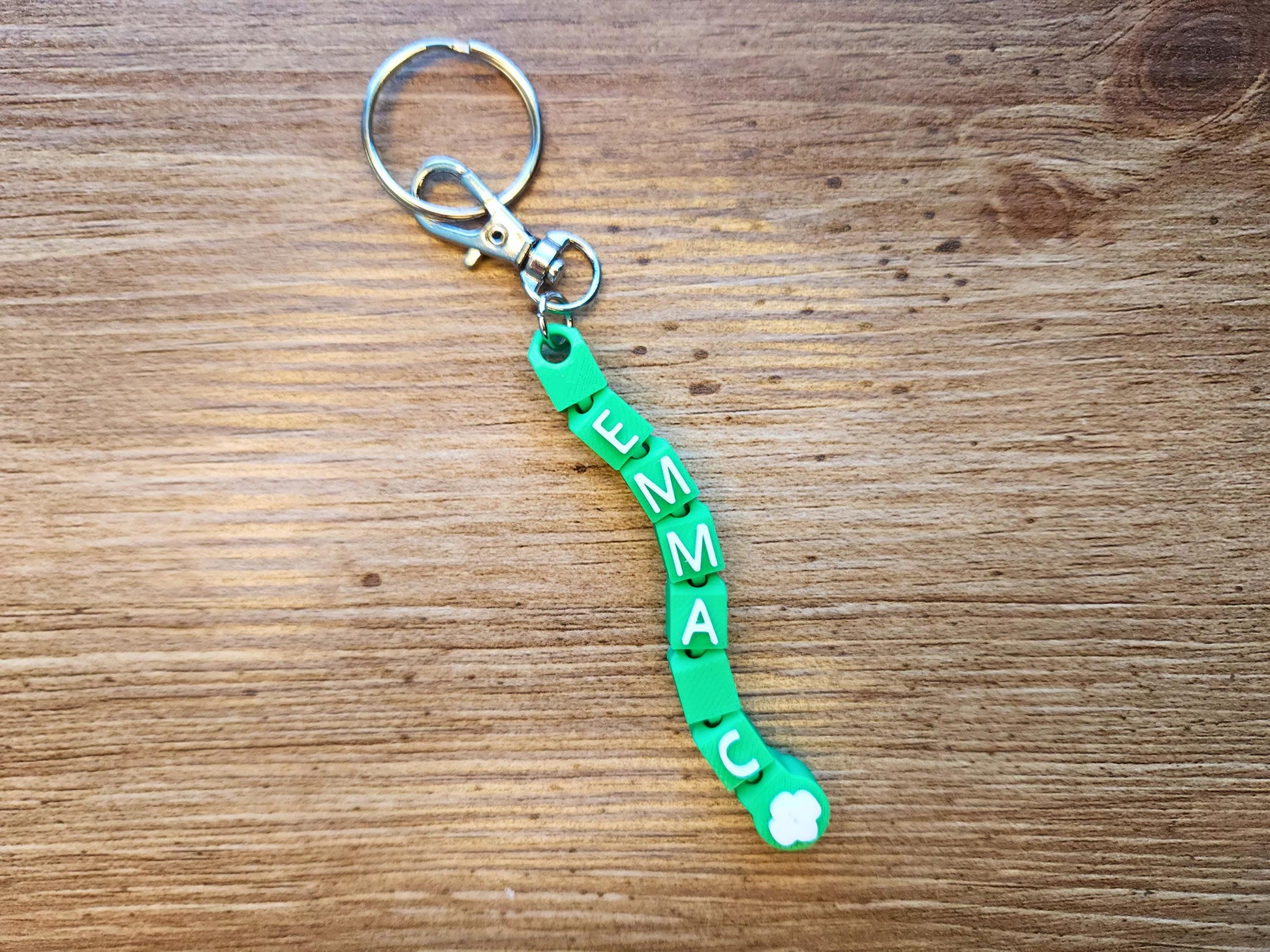 Green keychain featuring the name Emma. Perfect for girl scouts!