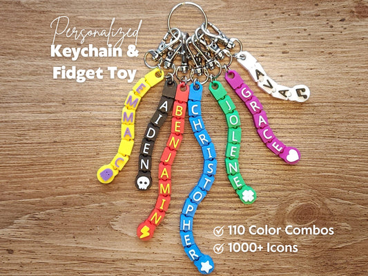 A cluster of vibrant keychains with names like BENJAMIN and JOLENE showcasing bright colors and unique symbols.