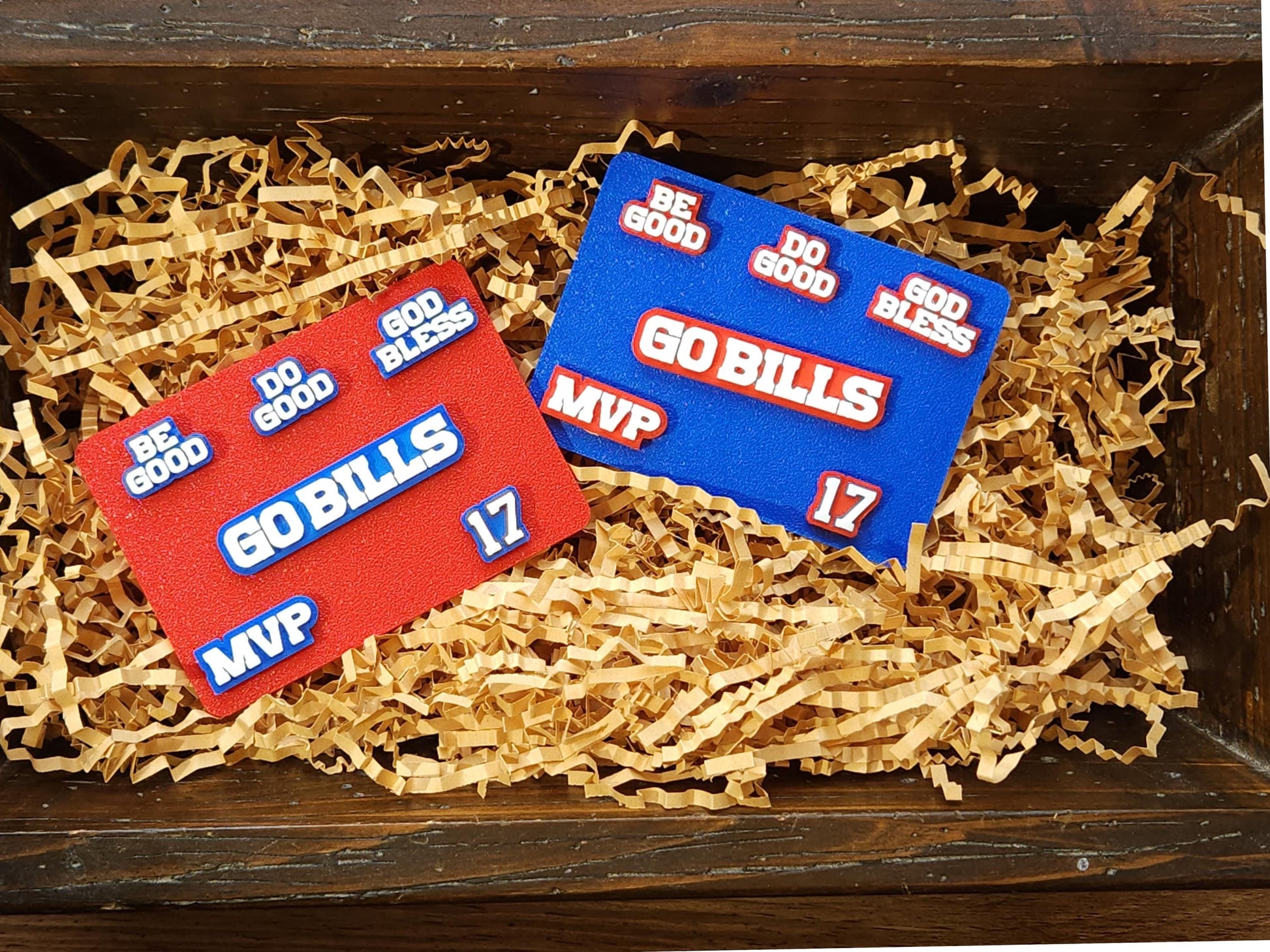 Buffalo Bills 6-pin set pictured in a basket. Pins pictured are white on a blue background or a red background and say Do Good Be Good God Bless Go Bills #17 MVP in honor of Buffalo Bills Josh Allen&#39;s MVP performance.