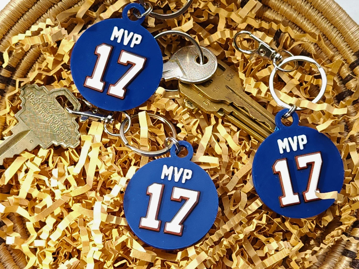 Several blue keychain sfeaturing the number 17 and phrase MVP in a bowl to commemorate Josh Allen&#39;s 2024 MVP Season with the Buffalo Bills.