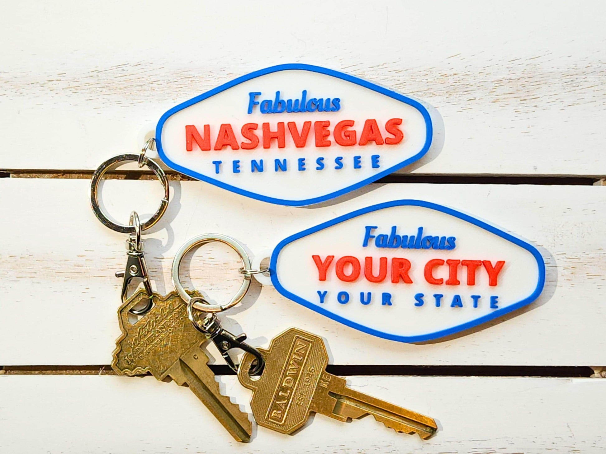 Fabulous Nashvegas and customizable YOUR CITY keychains styled with vintage brass keys on white background