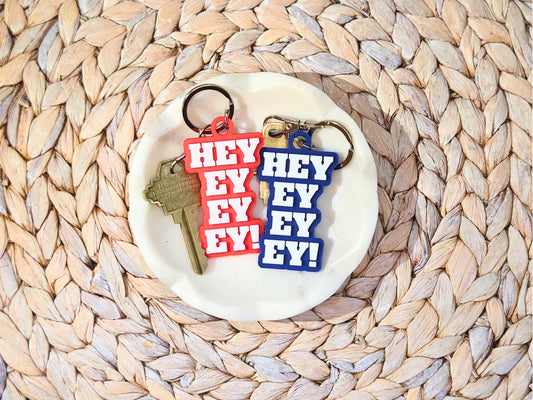 Red and blue “Hey Ey Ey Ey” keychains inspired by Buffalo football touchdown song – unique 3D printed football keychains for sports lovers.