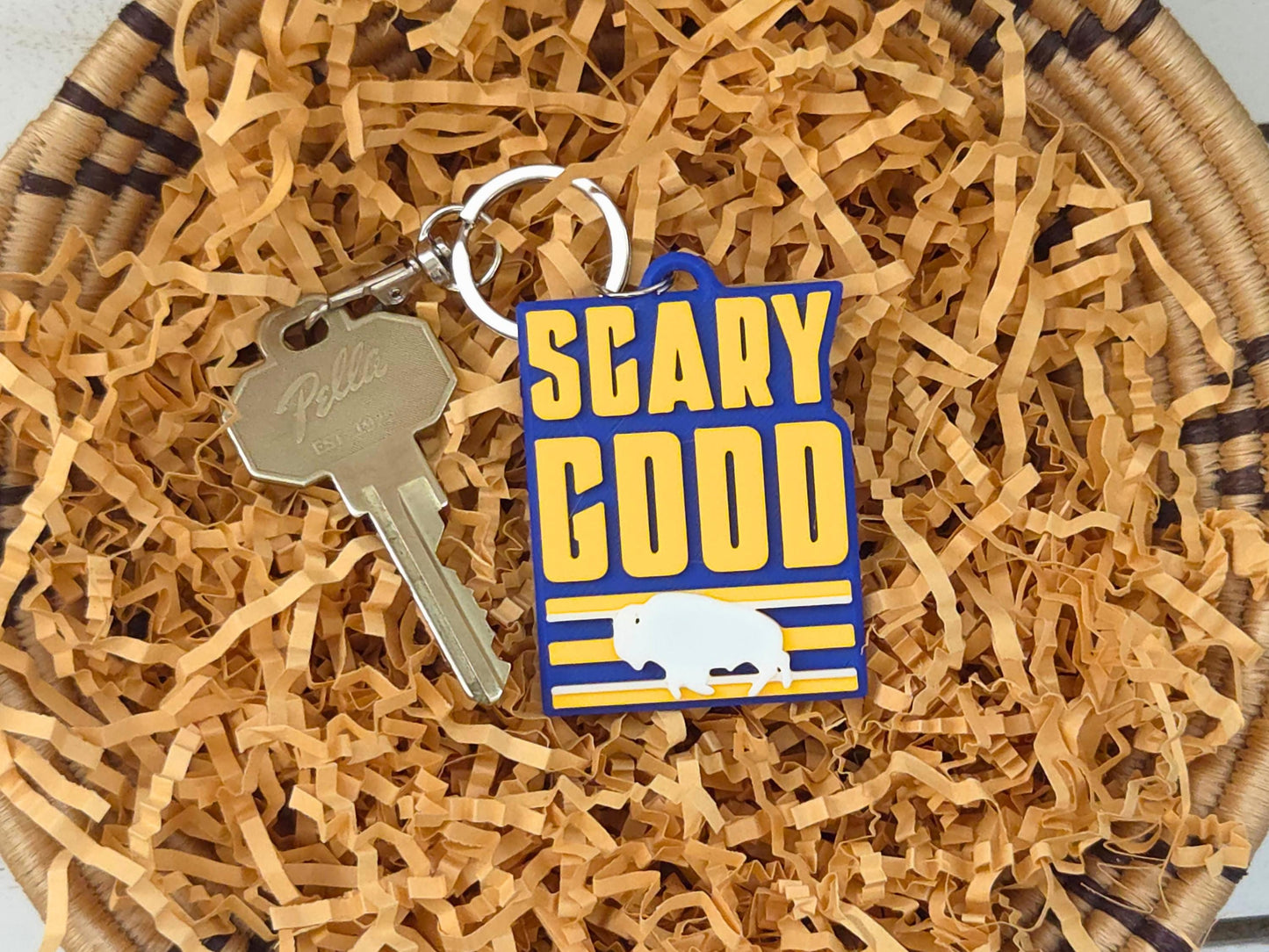3D-printed blue and yellow Buffalo hockey bag tag on tan gift filler, perfect for Mother's Day or game day surprises.