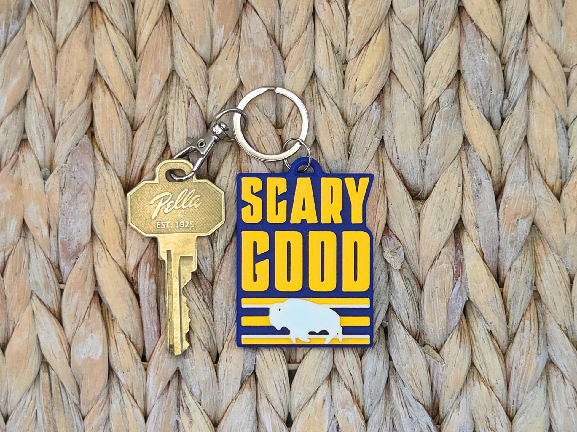 Close-up of a durable "Scary Good" Buffalo fan keychain highlighting the high-quality 3D-printed texture on straw.