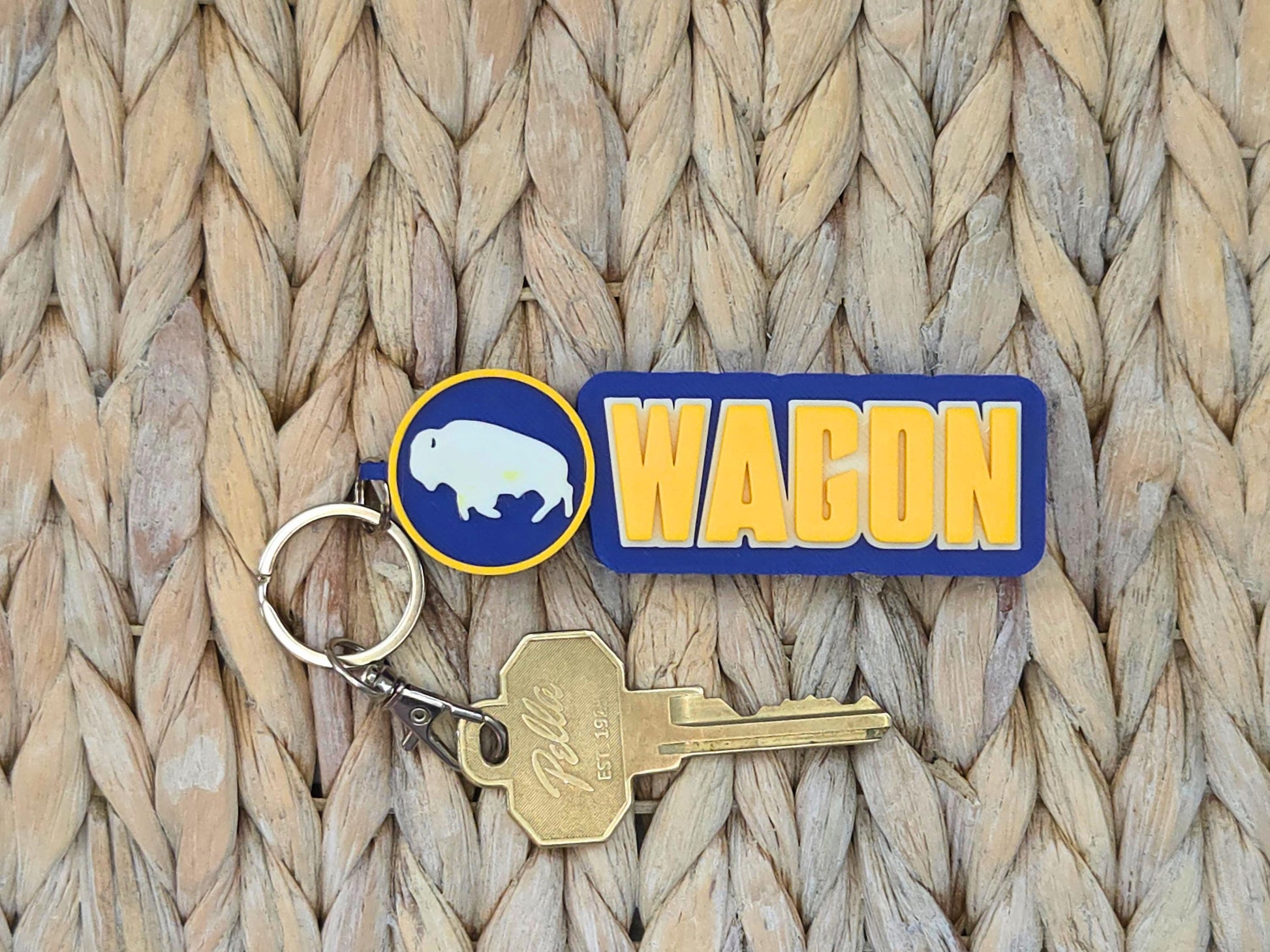 Close-up of a durable blue and gold "Wagon" keychain for hockey fans, highlighting the high-quality 3D-printed PLA texture.