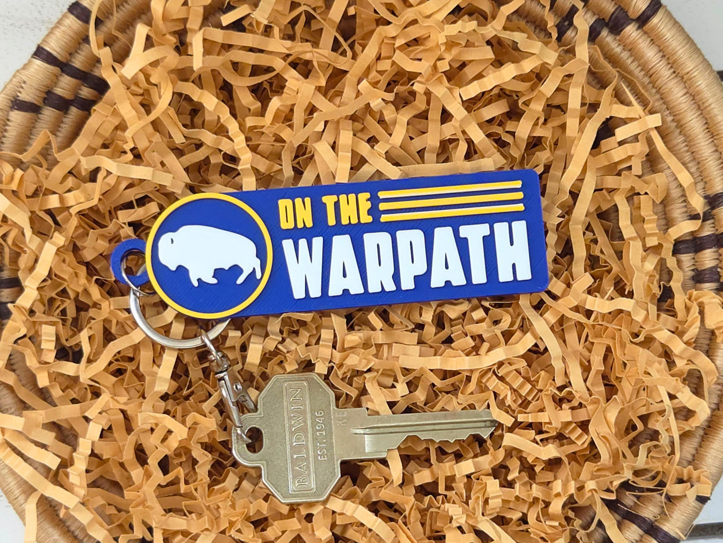 Handmade Buffalo hockey team color keychain on tan gift filler, a great gift idea for hockey moms and fans.